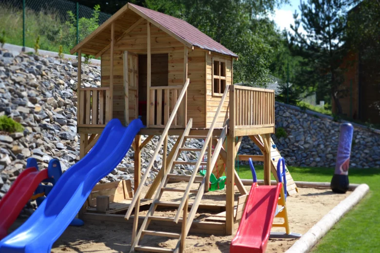 Wooden playhouse with slides