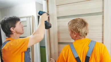 Workers installing door frame