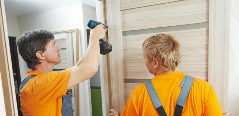Workers installing door frame