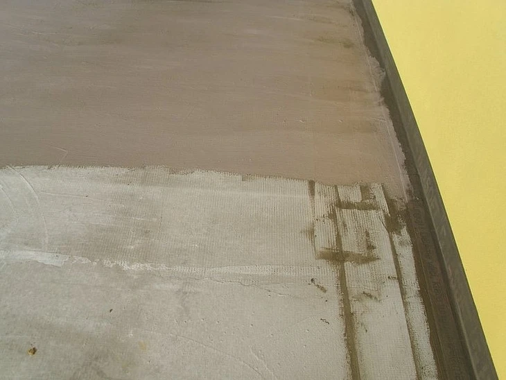 Nová vrstva podlahy na balkóně po nanesení omítky.
