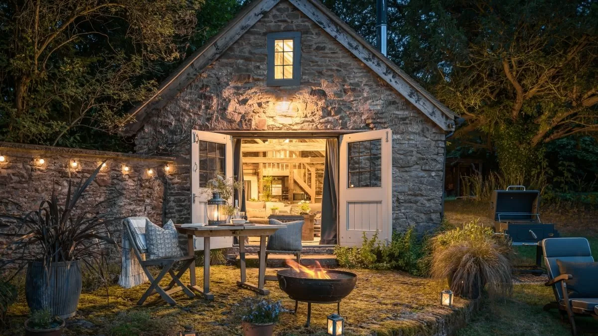Renovated stone cottage exterior at night